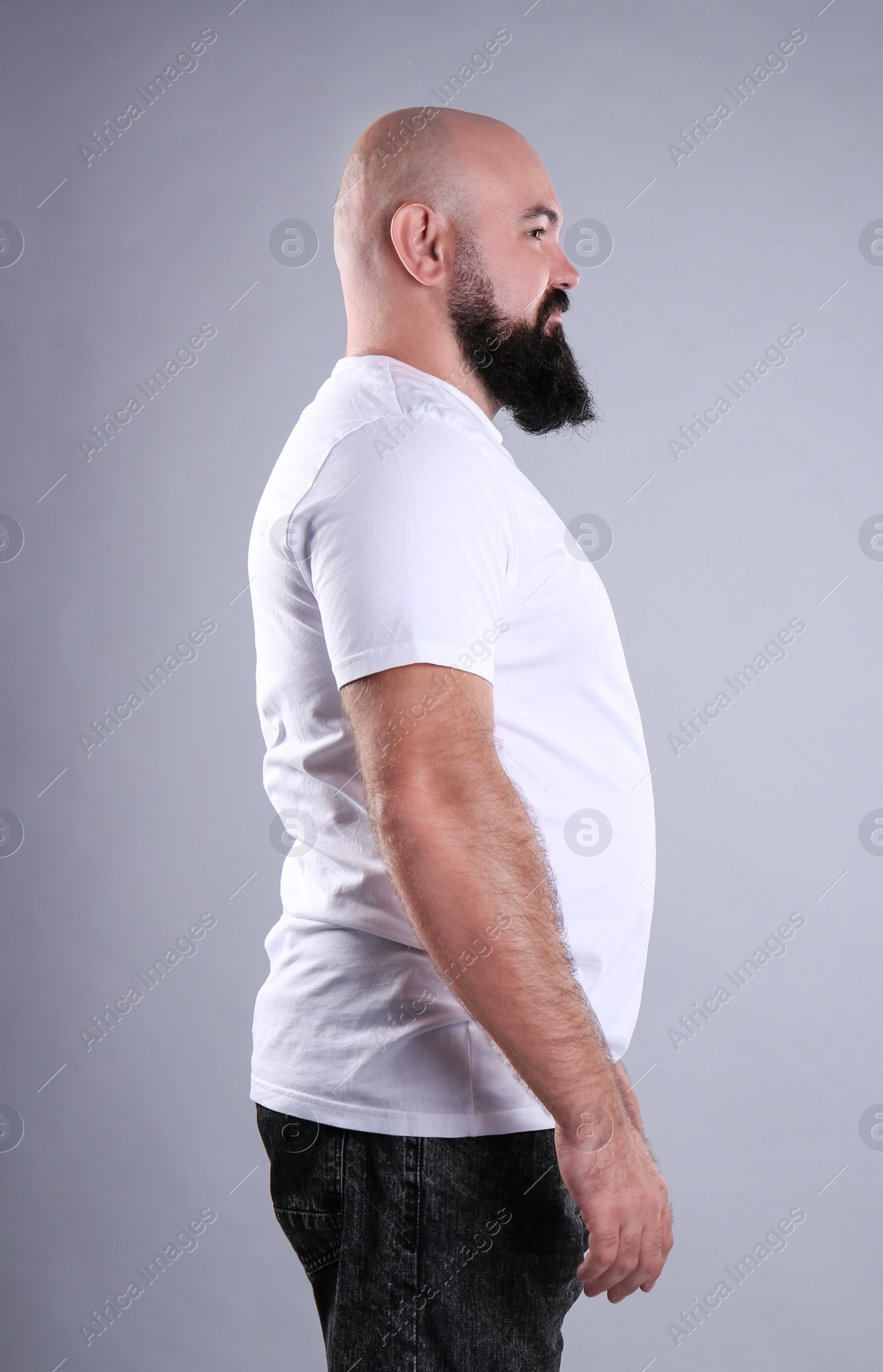 Photo of Fat man on grey background. Weight loss