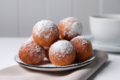 Photo of Delicious sweet buns with powdered sugar on table