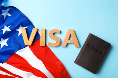 Flat lay composition with word VISA, passport and flag of USA on color background