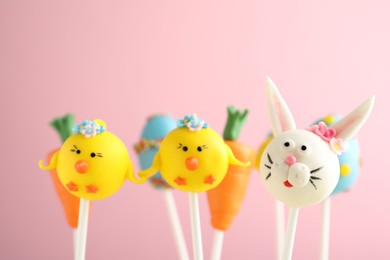 Photo of Delicious sweet cake pops on light pink background. Easter holiday