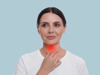Endocrine system. Woman doing thyroid self examination on light blue background