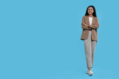 Photo of Beautiful secretary on light blue background, space for text