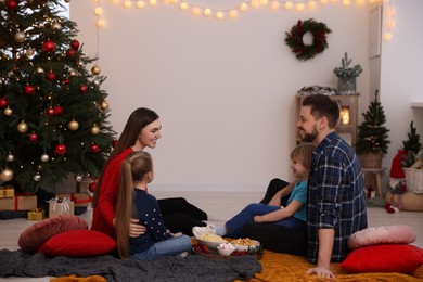 Family spending time together at TV area in cosy room. Christmas atmosphere