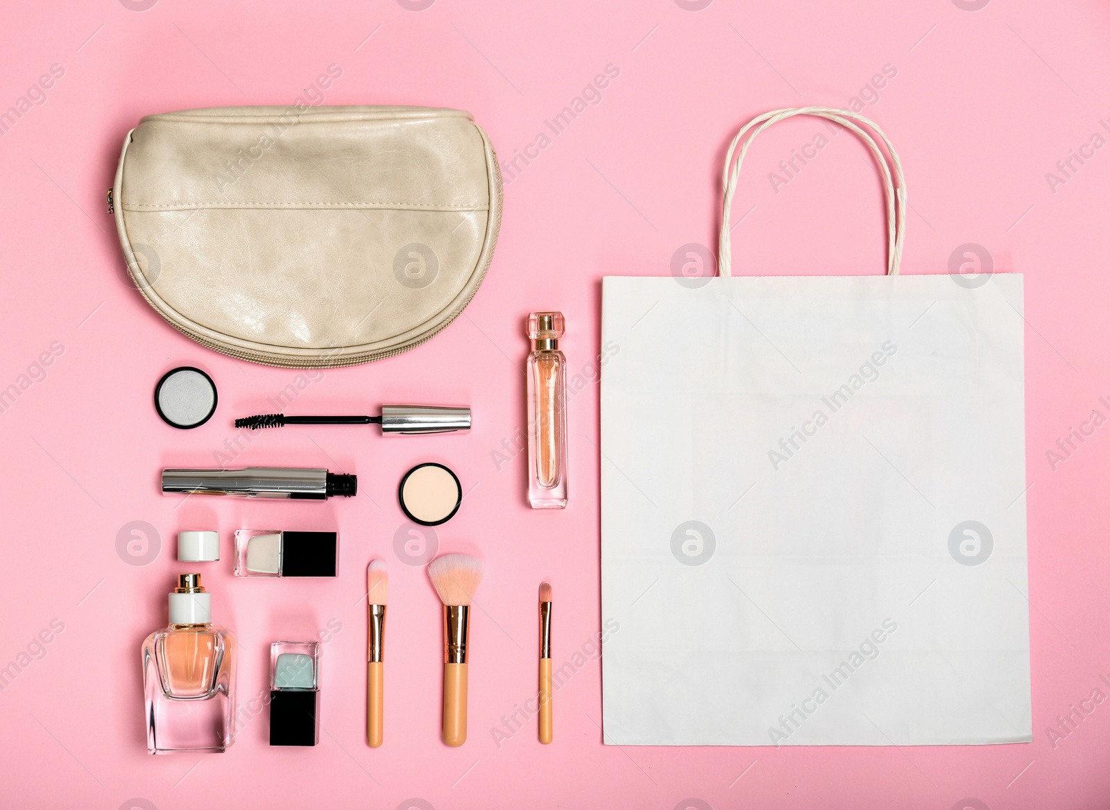 Photo of Flat lay composition with shopping bag and cosmetics on color background
