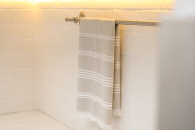 Photo of Clean kitchen towel hanging on wall indoors