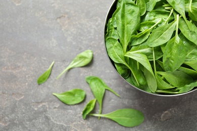 Fresh green healthy spinach on grey table, top view. Space for text