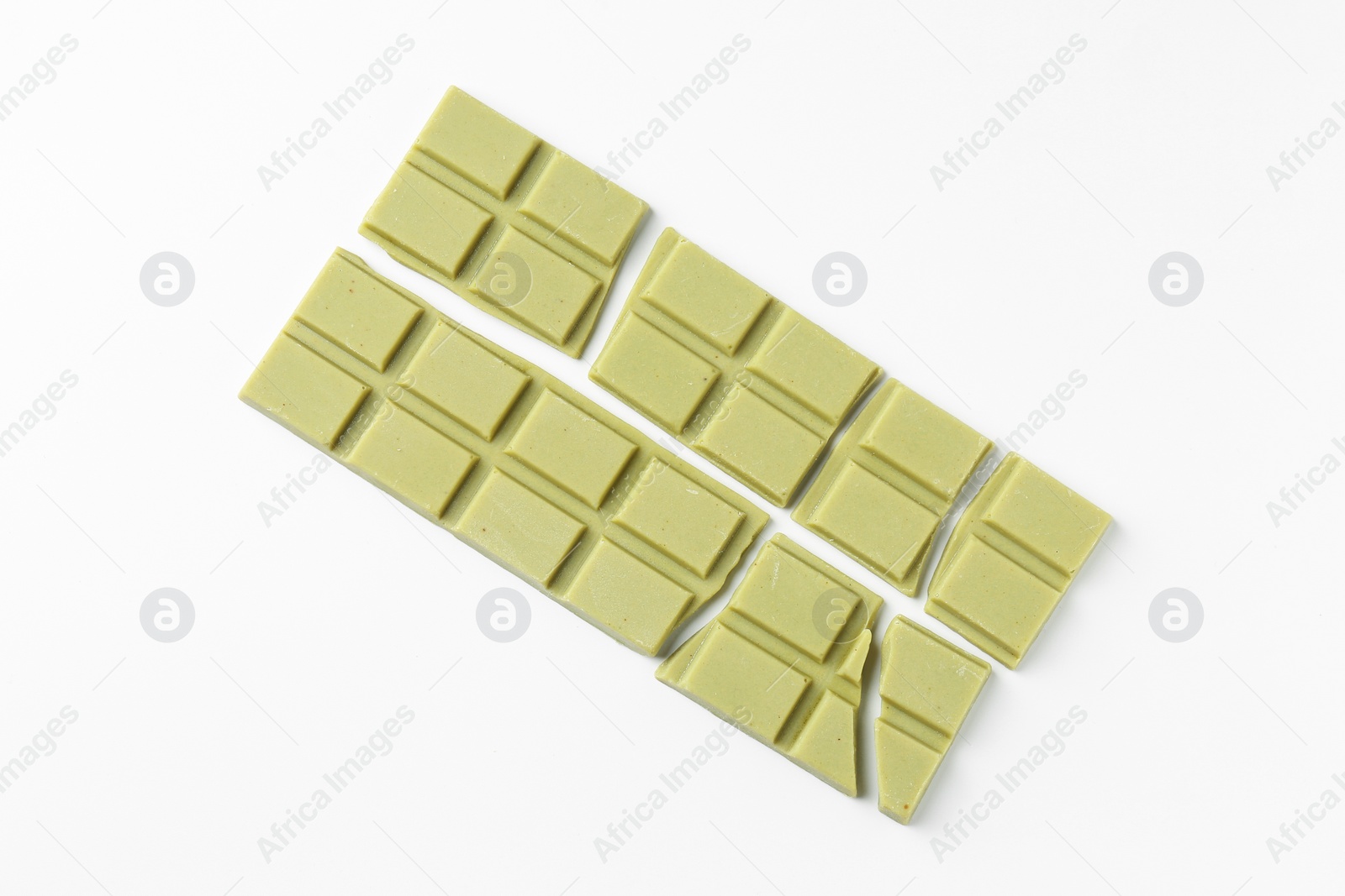 Photo of Pieces of tasty matcha chocolate bars on white background, top view