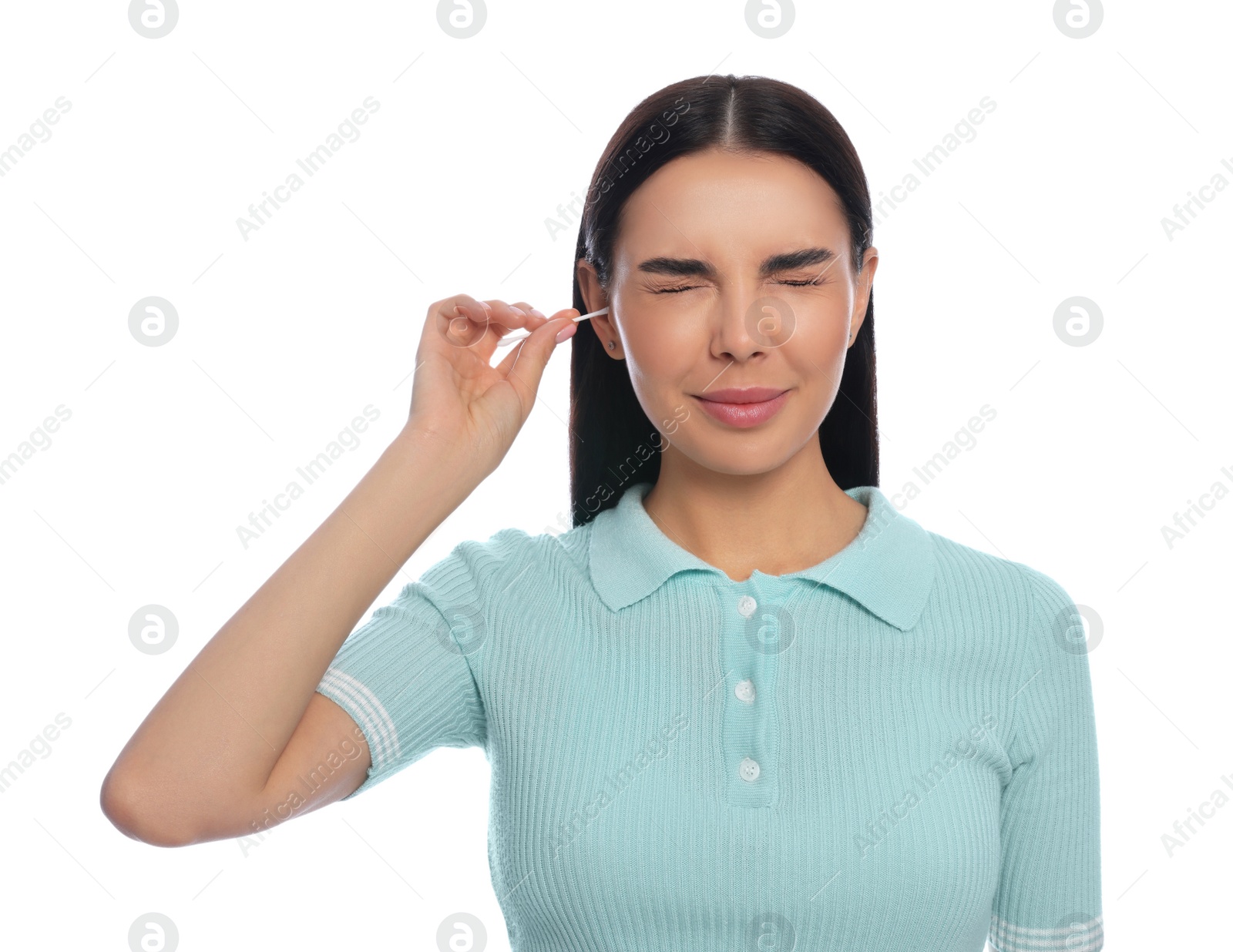 Photo of Young woman cleaning ear with cotton swab on white background