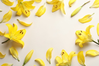 Photo of Flat lay composition with lily flowers on light background