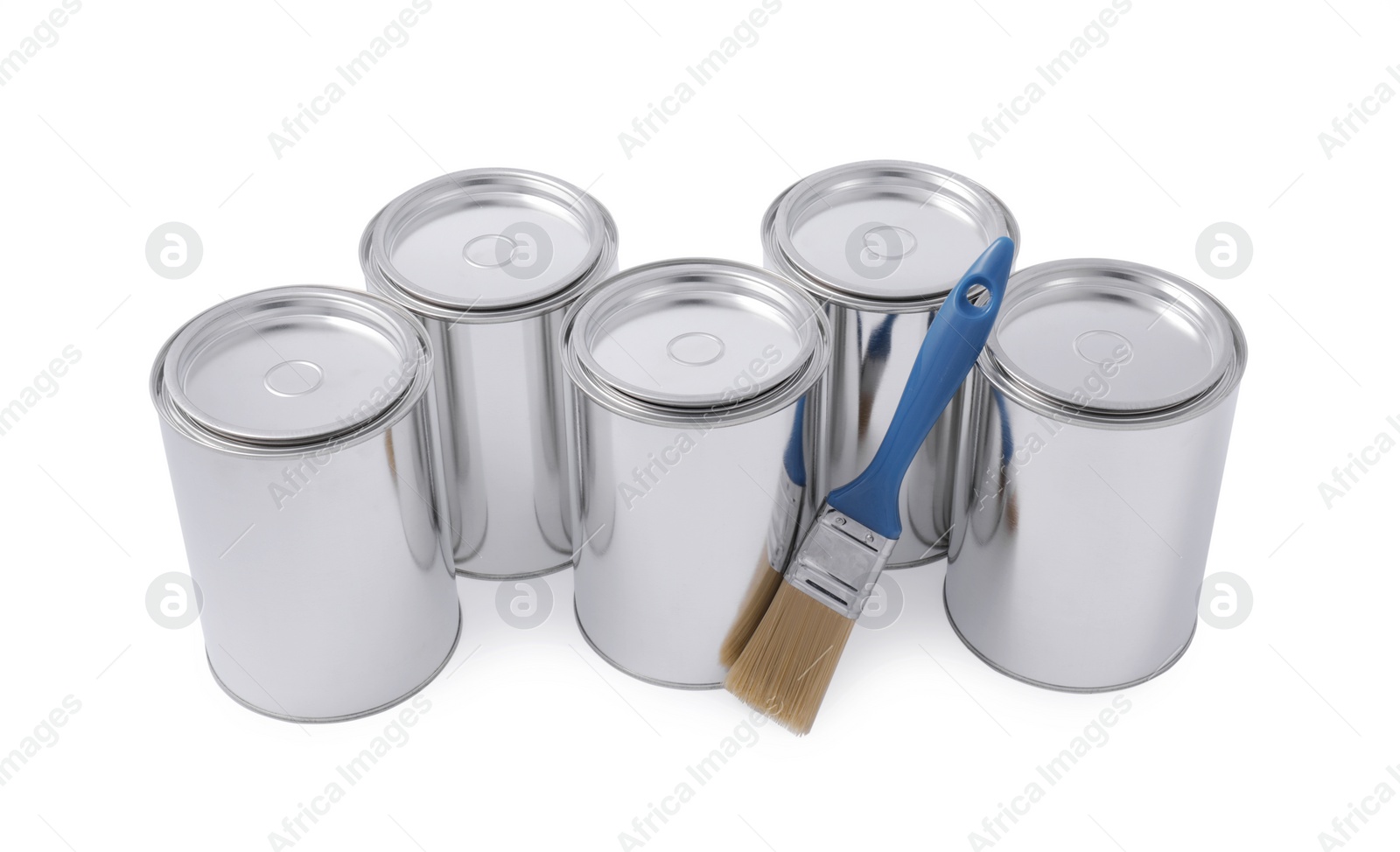 Photo of Cans of paints and brush on white background