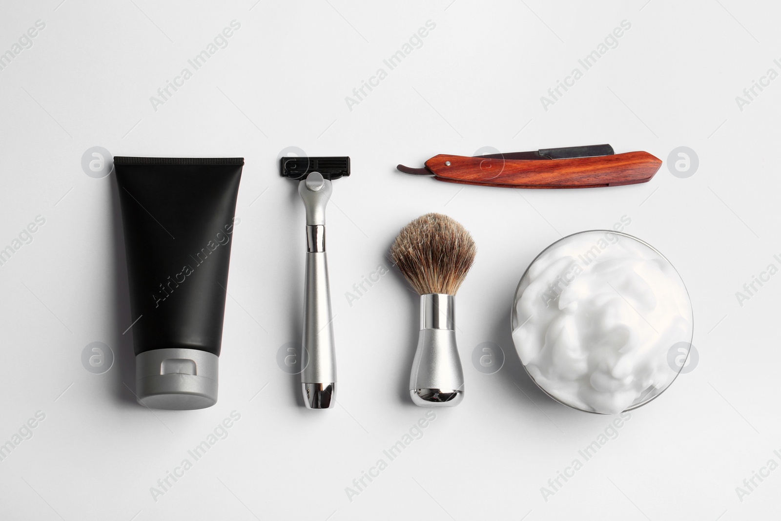 Photo of Set of shaving equipment and men's cosmetic products on light background, top view