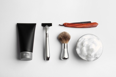 Photo of Set of shaving equipment and men's cosmetic products on light background, top view