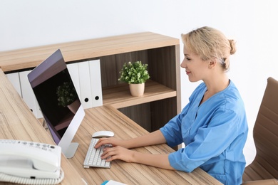 Photo of Female medical assistant at workplace in clinic. Health care service