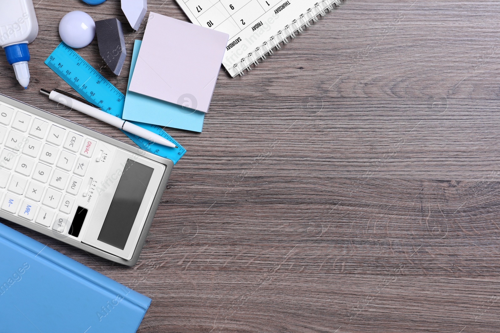 Photo of Different school stationery on wooden table, flat lay. Space for text