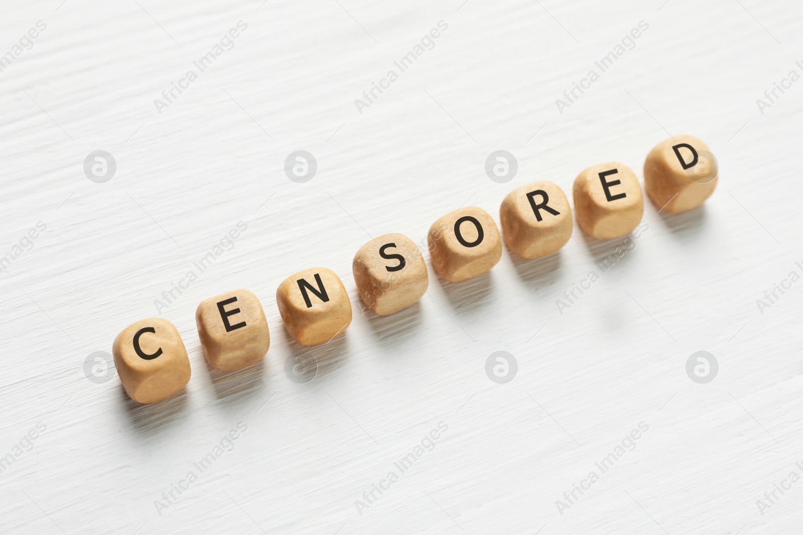 Photo of Wooden cubes with word Censored on white table