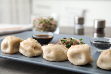 Plate with tasty baozi dumplings on table, closeup