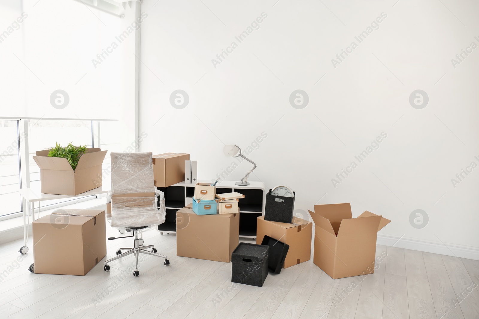 Photo of Moving boxes and furniture in new office