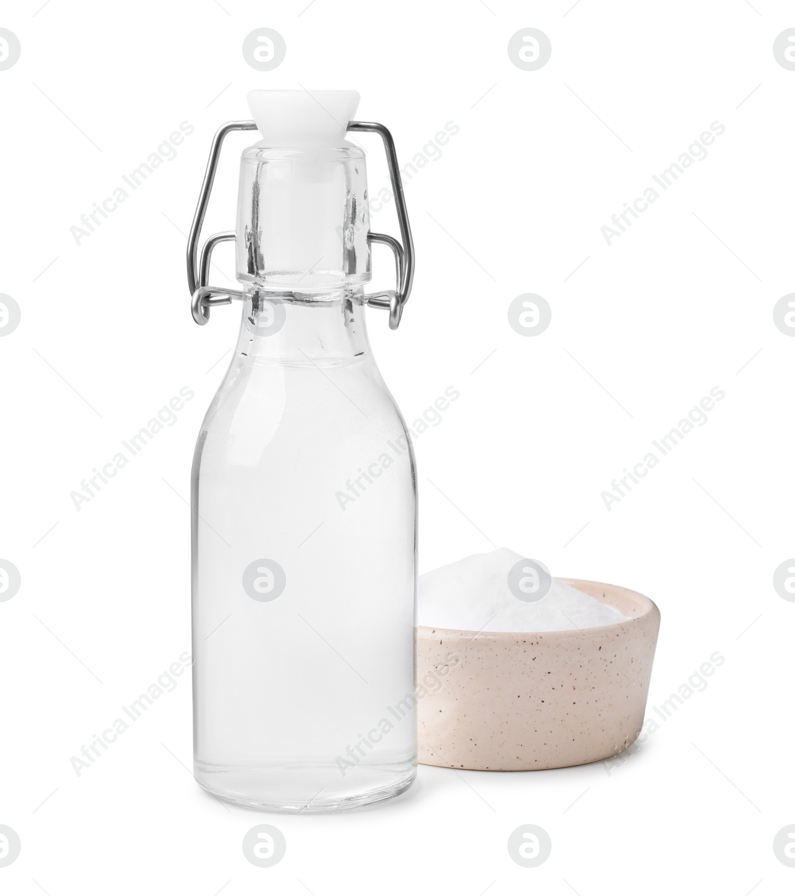 Photo of Vinegar in glass bottle and baking soda isolated on white