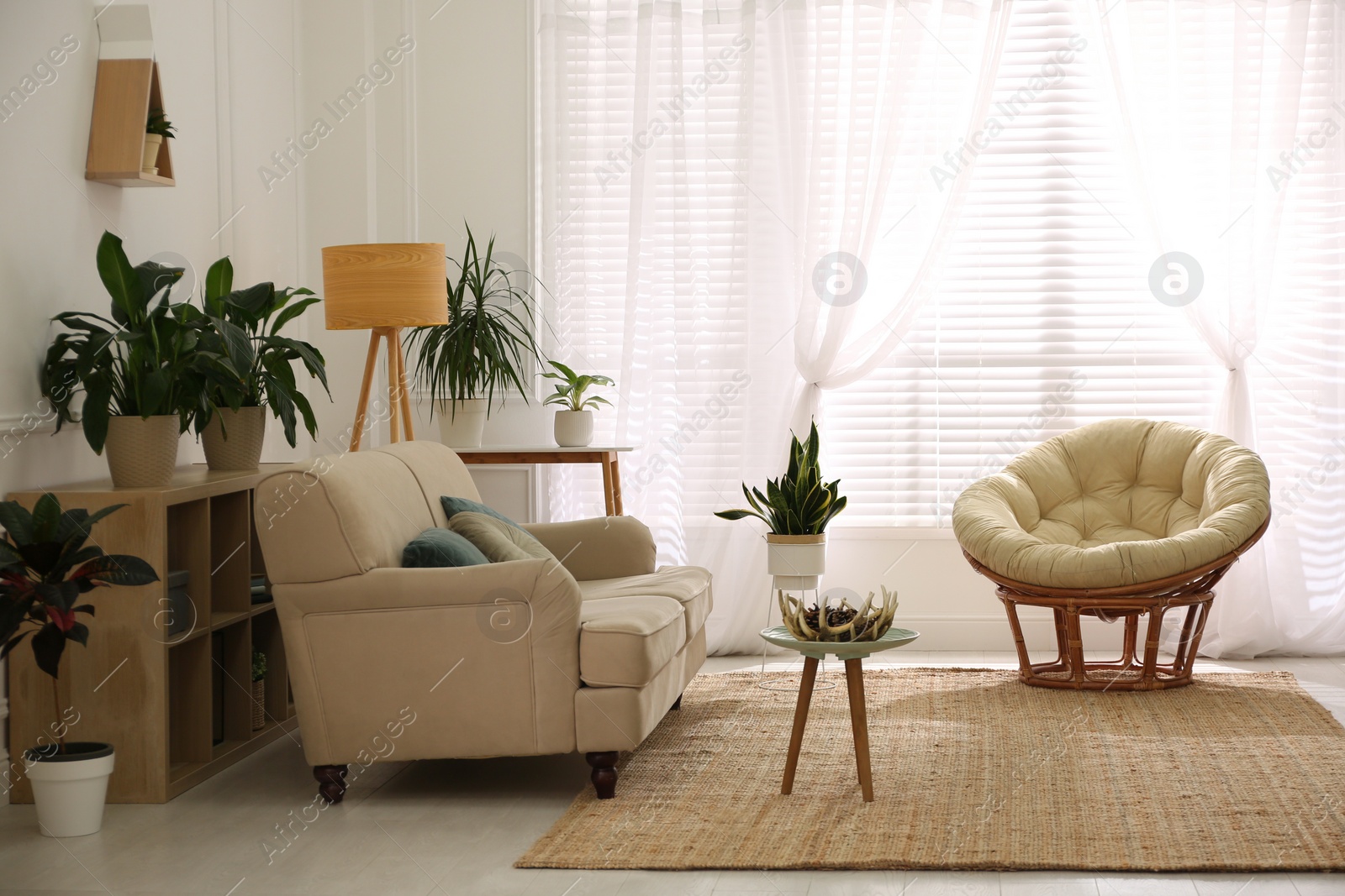 Photo of Stylish living room interior with comfortable sofa and cushions