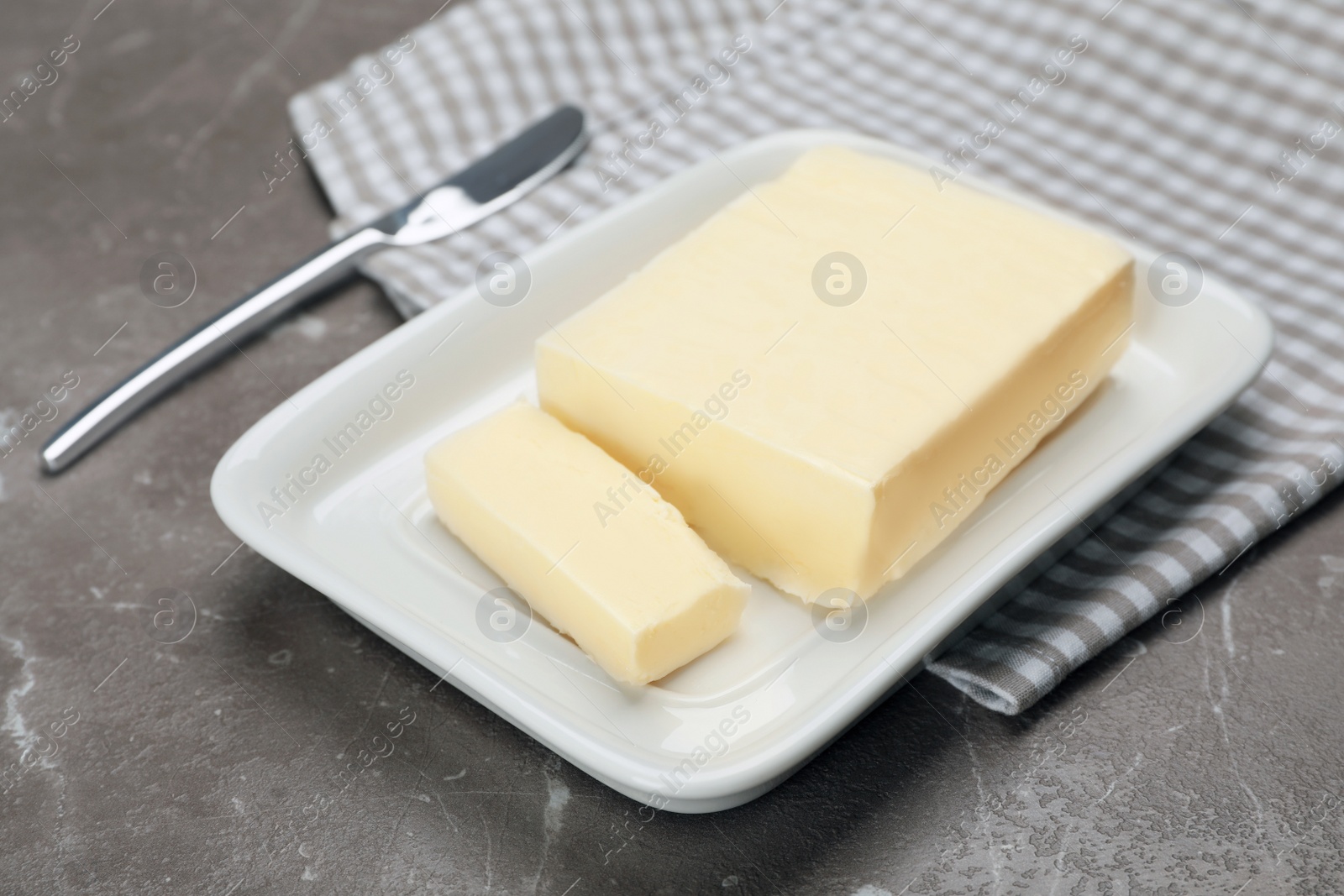 Photo of Plate with tasty fresh butter on table