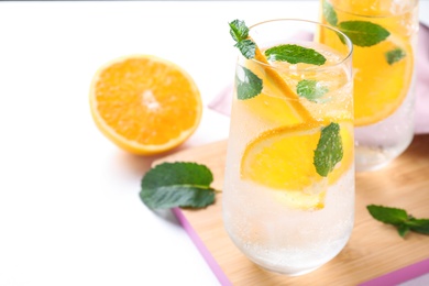 Photo of Delicious refreshing drink on white table, closeup. Space for text