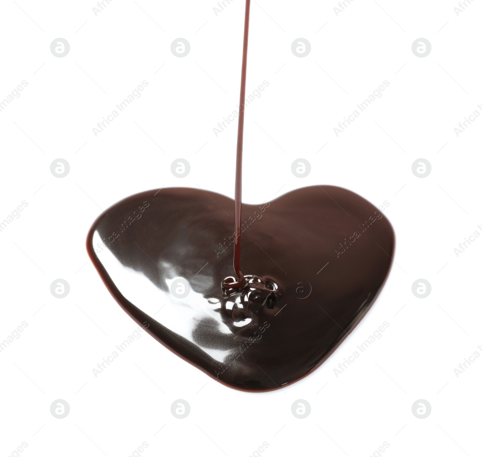 Photo of Pouring chocolate syrup into heart shaped puddle on white background