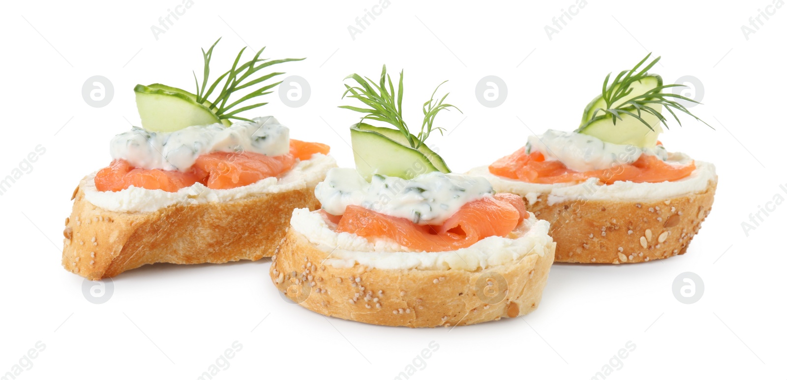 Photo of Tasty canapes with salmon, cucumber, cream cheese and dill isolated on white