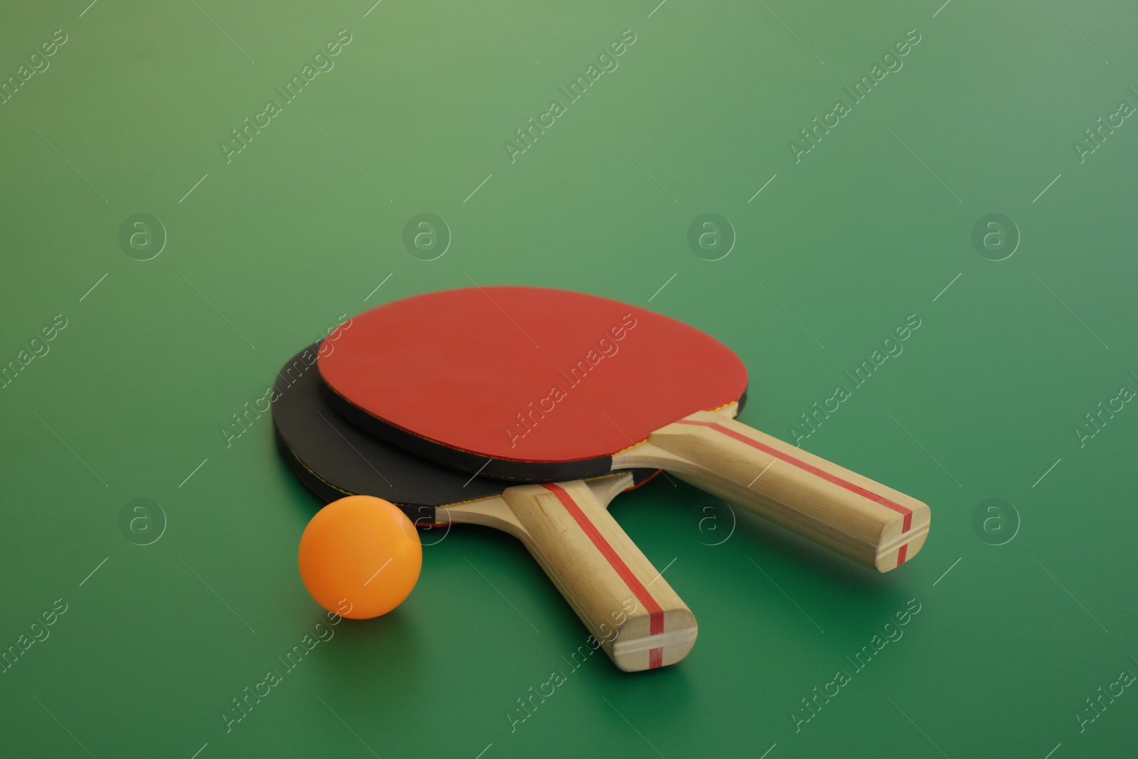 Photo of Rackets and ball on ping pong table