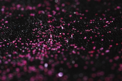 Photo of Pink glitter with bokeh effect on dark background