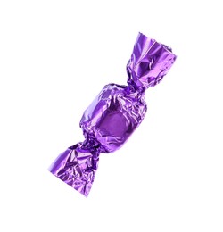 Photo of Tasty candy in purple wrapper isolated on white