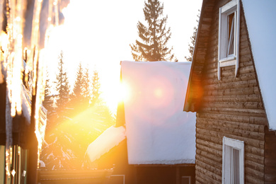 Wooden houses covered with snow. Winter vacation