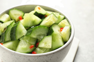 Photo of Delicious cucumber salad in bowl on table, closeup