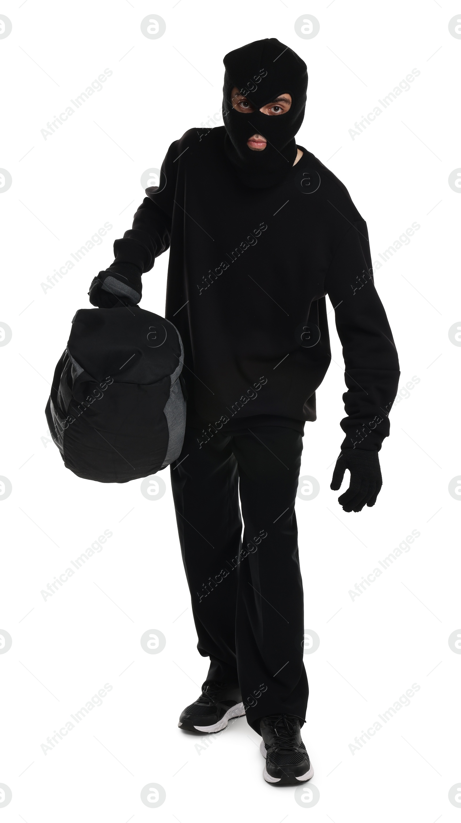 Photo of Thief in balaclava with bag on white background