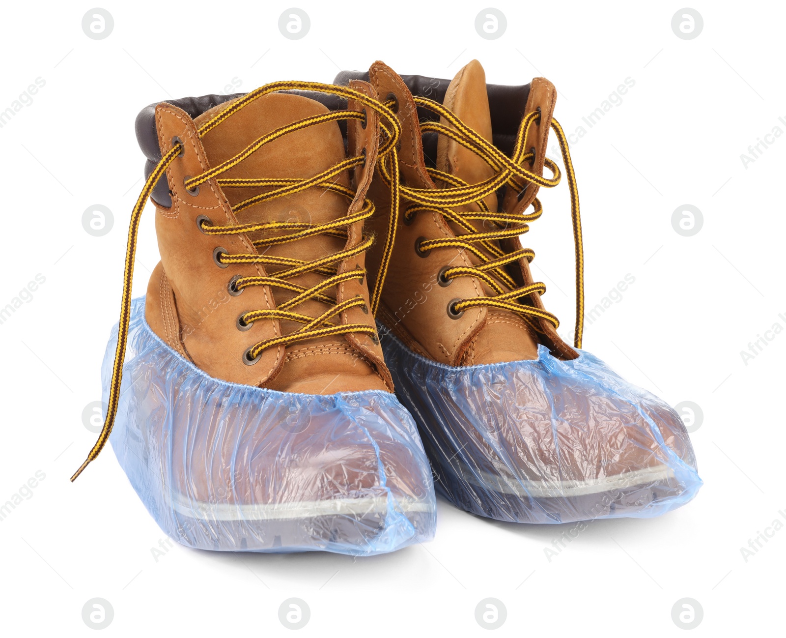 Photo of Boots in blue shoe covers isolated on white