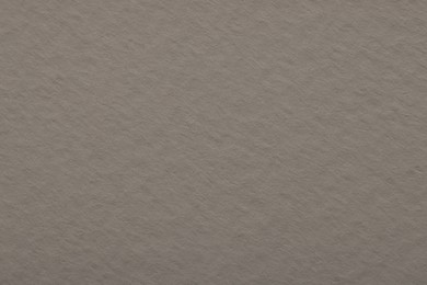 Photo of Texture of light grey paper sheet as background, top view