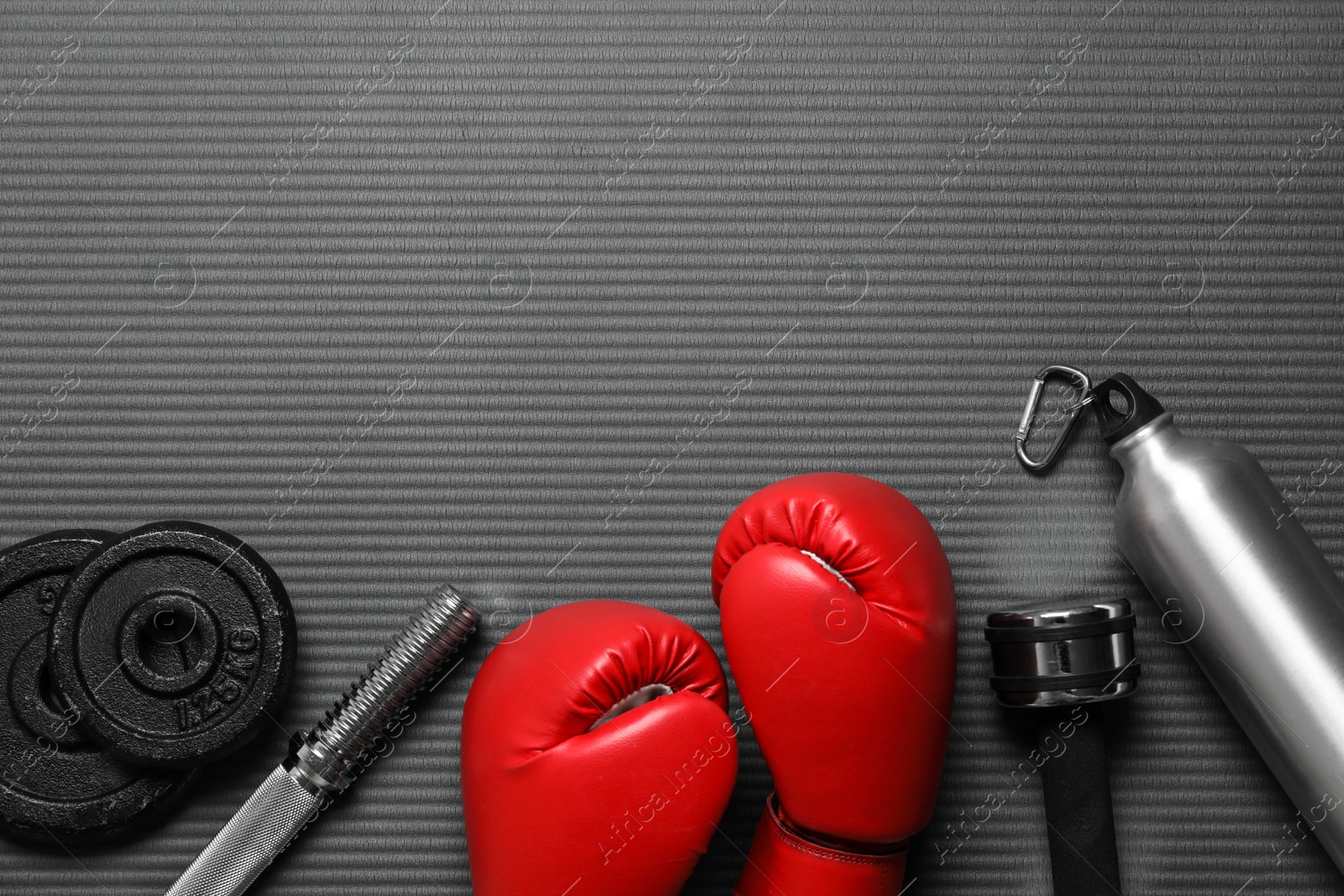 Photo of Flat lay composition with sports equipment on grey mat, space for text