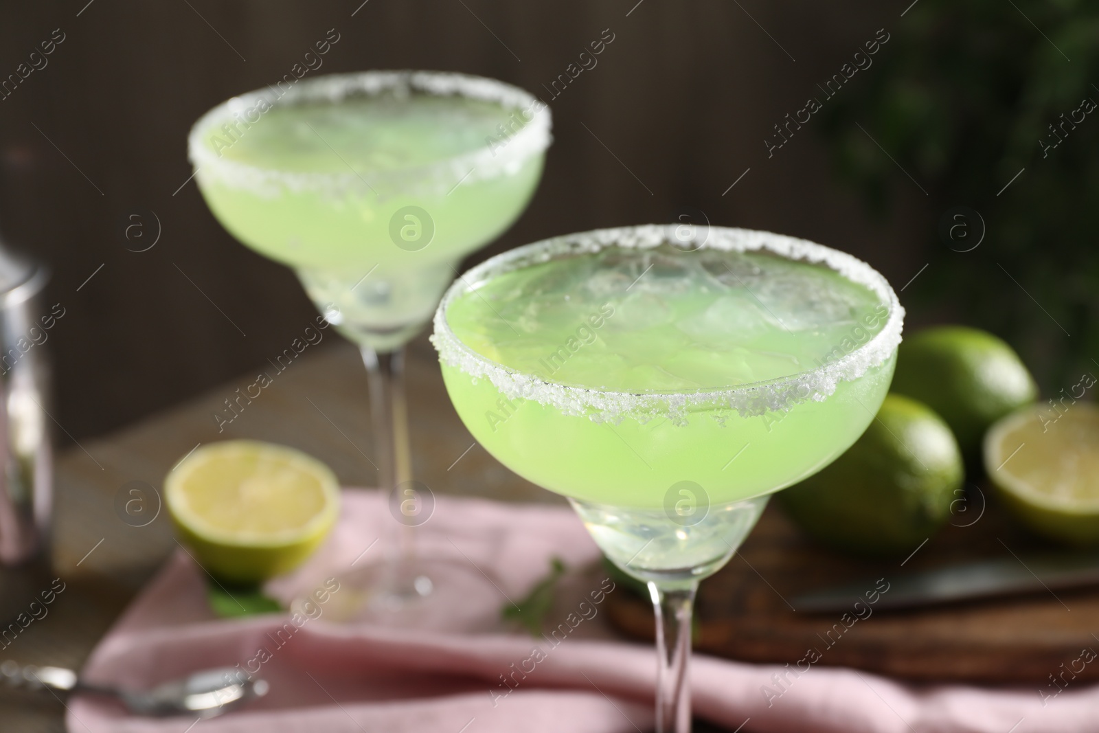 Photo of Delicious Margarita cocktail in glasses on table, closeup