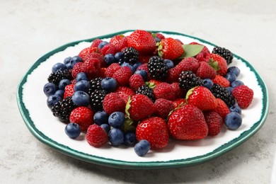 Photo of Different fresh ripe berries on light grey table, closeup