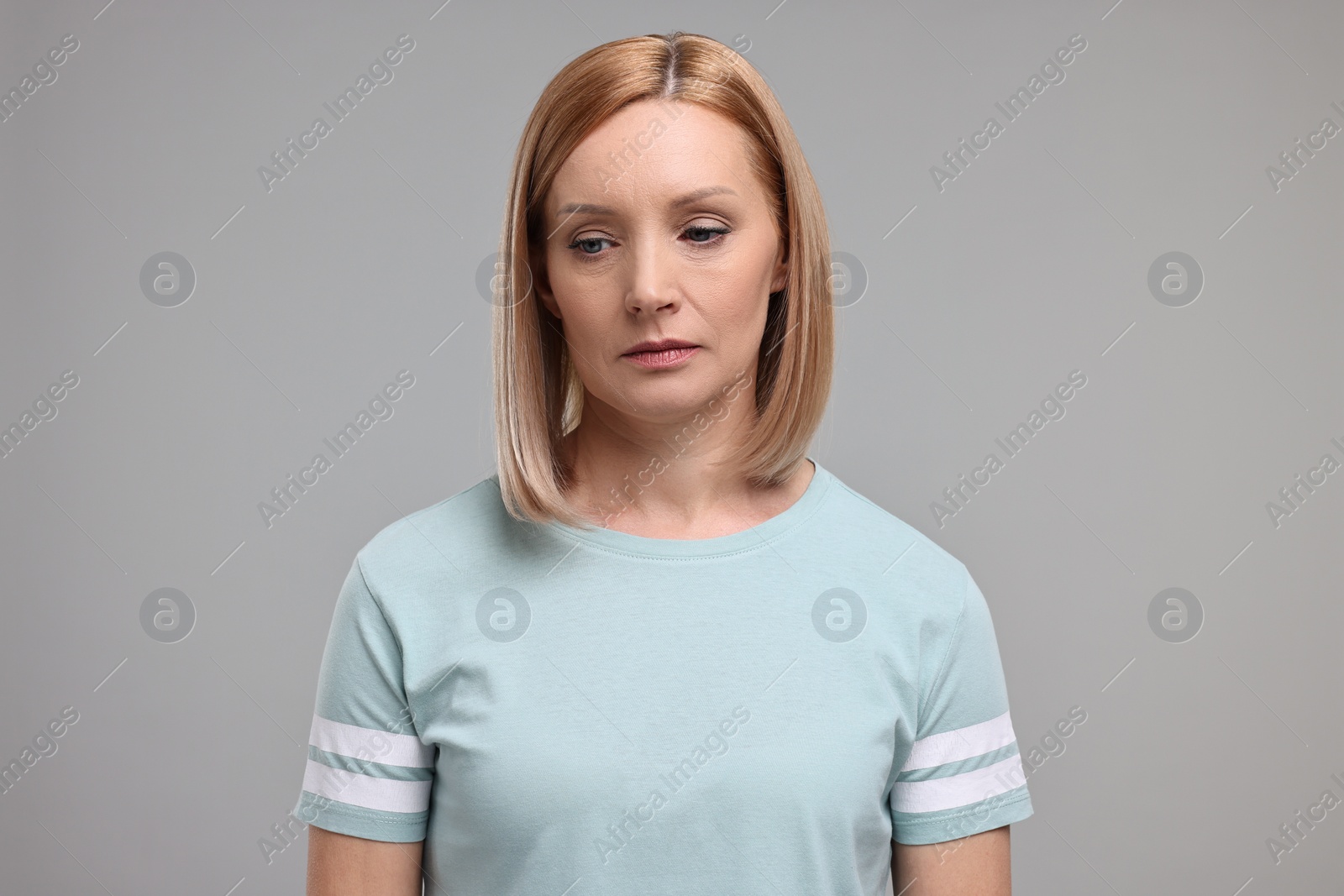 Photo of Portrait of sad woman on grey background