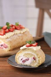 Photo of Delicious cake roll with strawberries and cream on wooden table