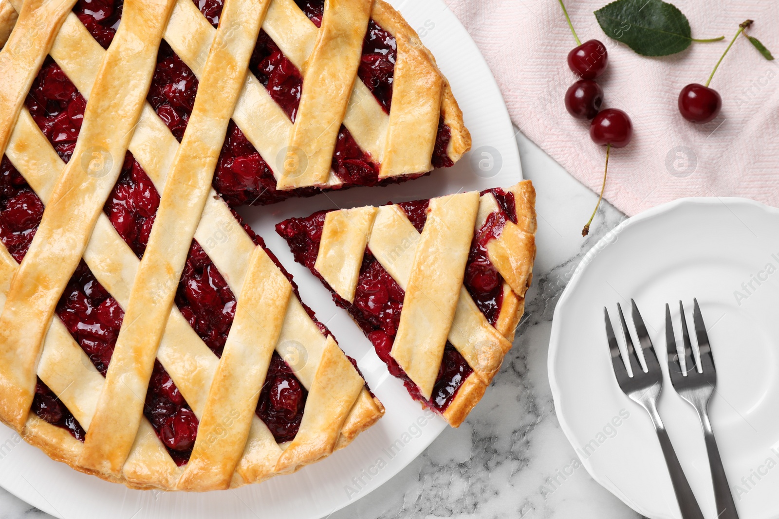 Photo of Delicious fresh cherry pie served on white marble table, flat lay