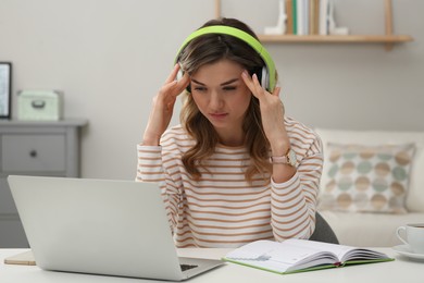 Online test. Woman studying with laptop at home