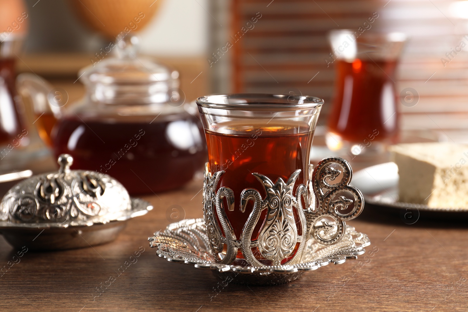 Photo of Traditional Turkish tea served in vintage tea set on wooden table