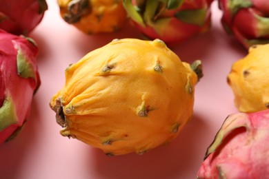 Photo of Delicious yellow pitahaya fruit on light pink background, closeup