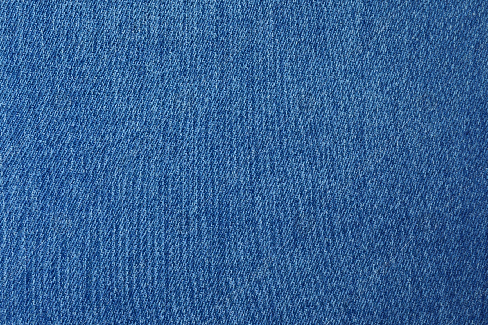 Photo of Texture of blue jeans as background, closeup