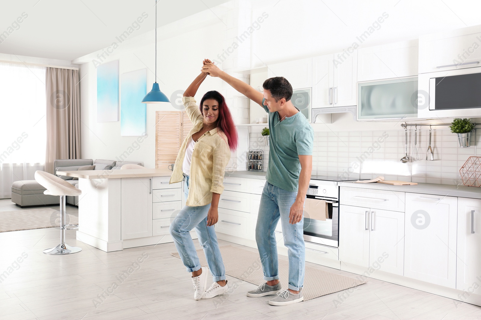 Photo of Beautiful couple dancing in kitchen at home