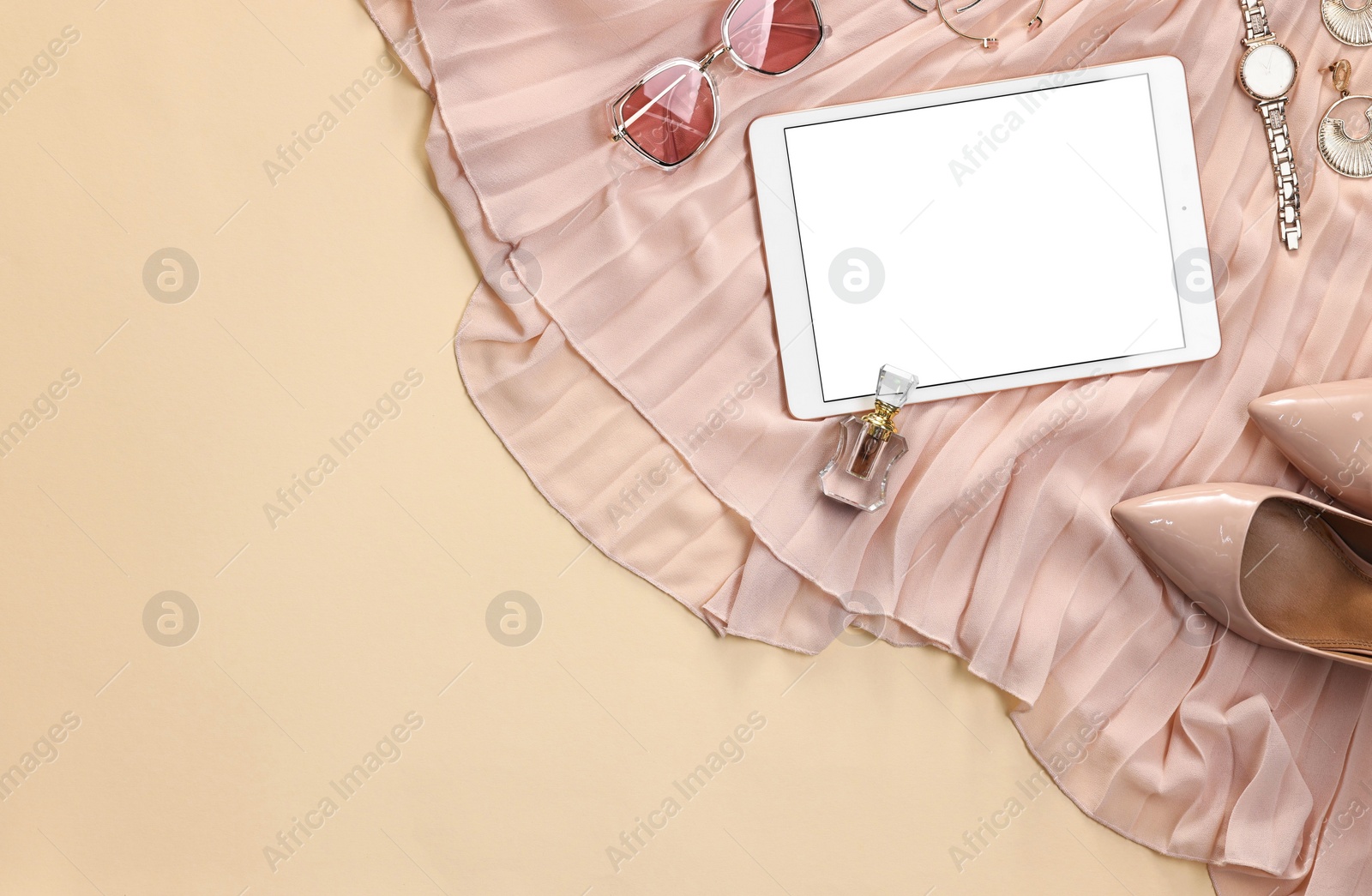 Photo of Flat lay composition with modern tablet on beige background. Space for text