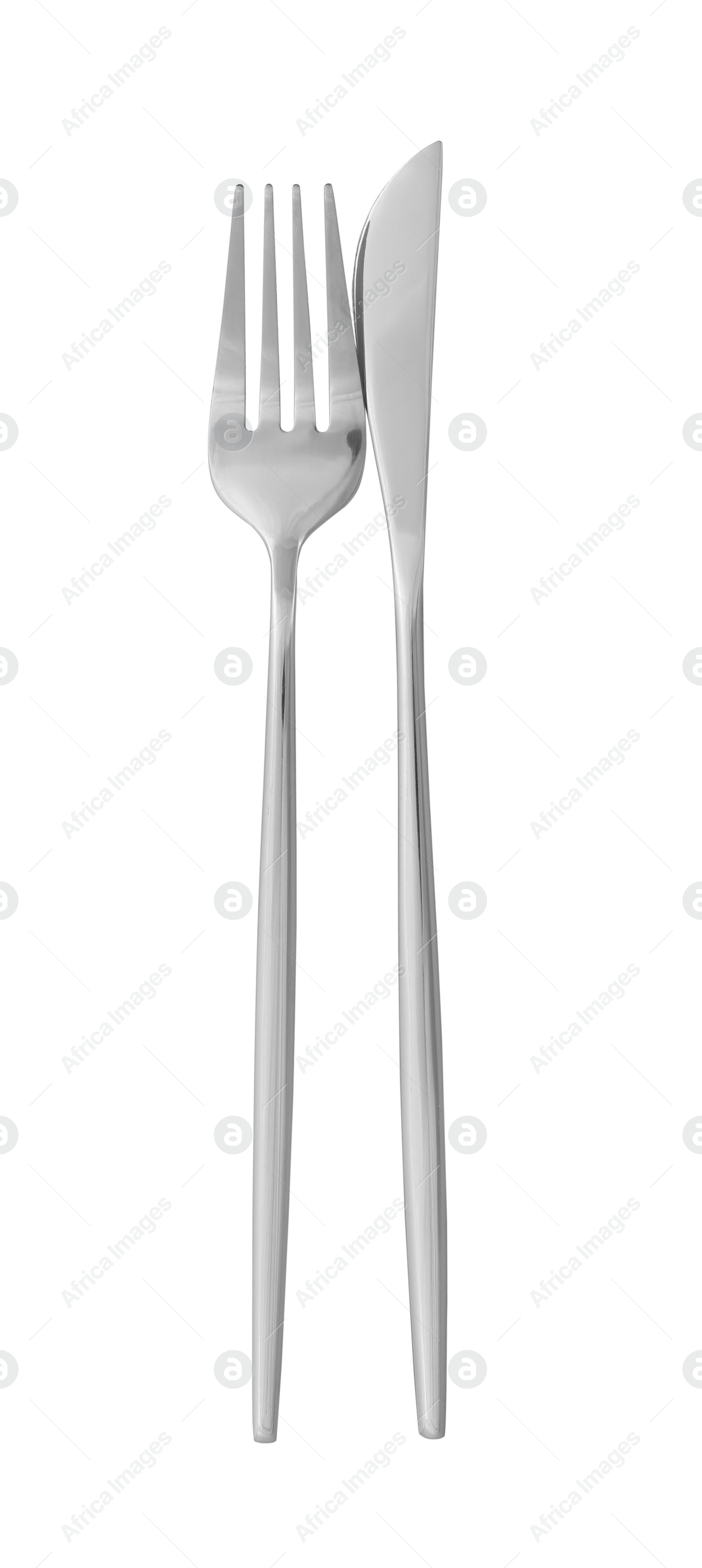 Photo of Knife and fork isolated on white, top view. Stylish shiny cutlery set