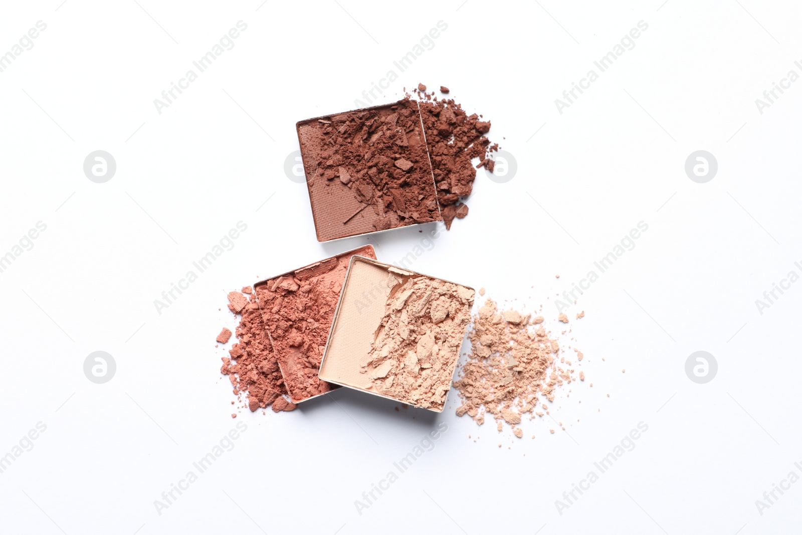 Photo of Different crushed eye shadows on white background, top view