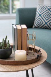 Stylish tray with different interior elements on wooden table in room